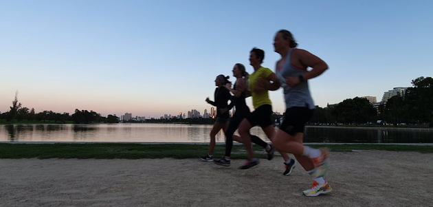Tri Alliance athletes running together beside Albert Park Lake