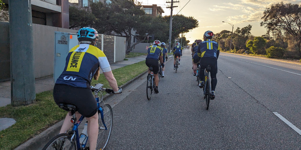 Tri Alliance athletes riding predictably together on the road
