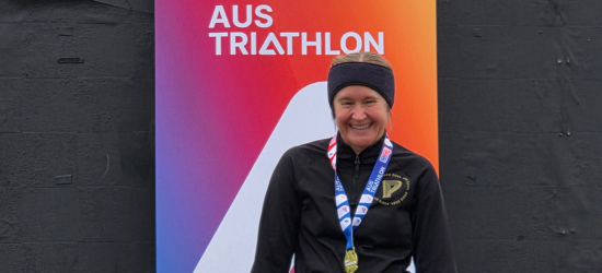 Tri Alliance athlete with a medal at an AusTriathlon duathlon