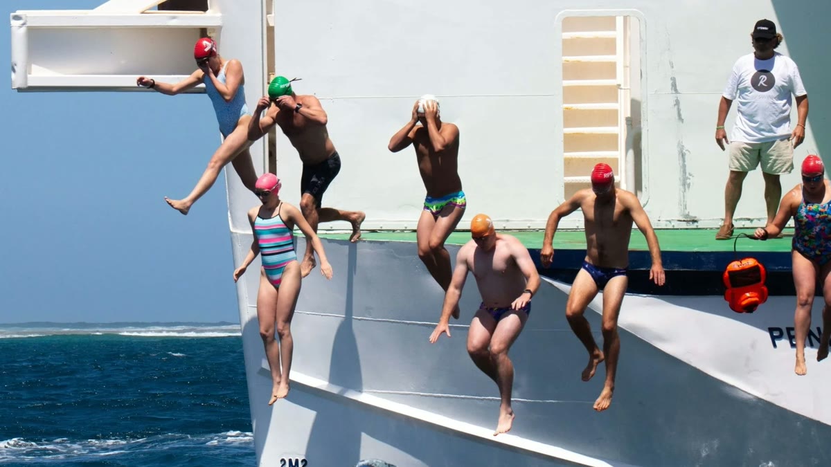 Swimmers jumping from the ferry for the Escape from Quarantine event