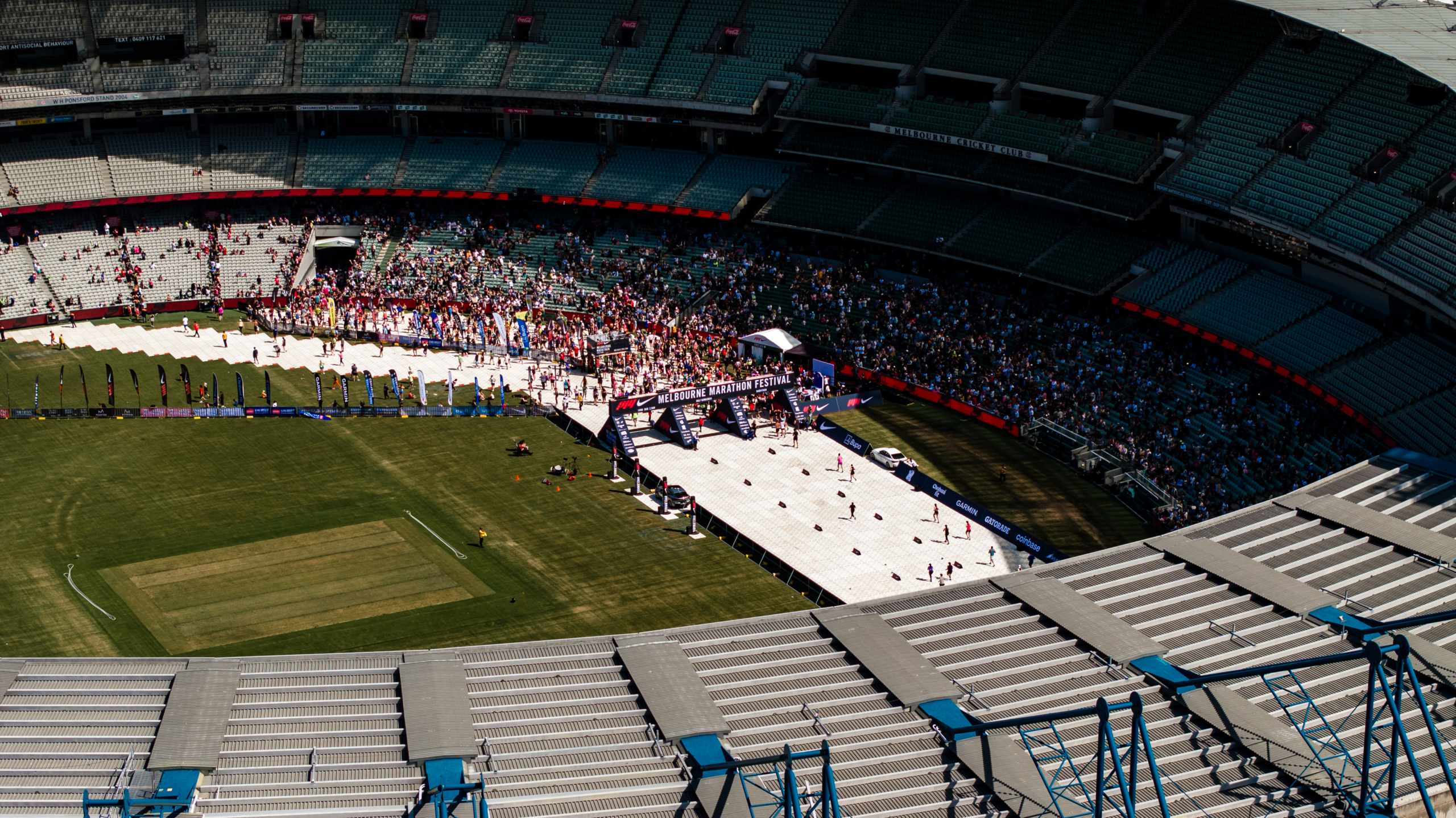 Runners approaching the Melbourne Marathon finish line inside the MCG